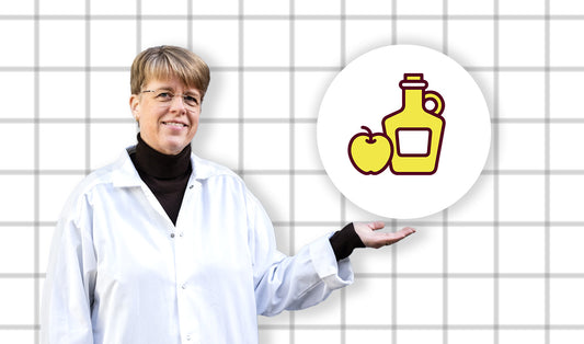 Dr. Elin Östman håller upp en ikon som föreställer en vinägerflaska och ett äpple